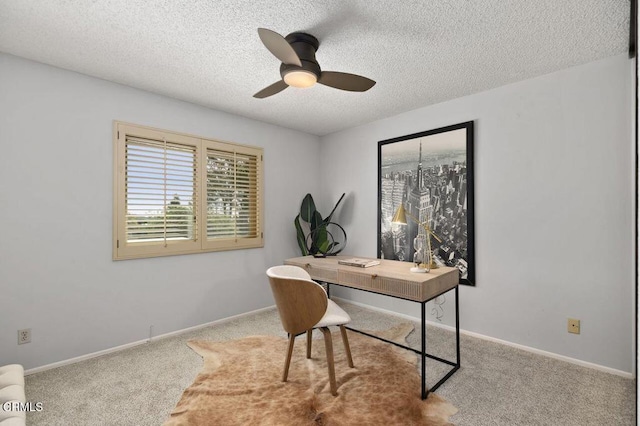 home office featuring ceiling fan, light carpet, and a textured ceiling