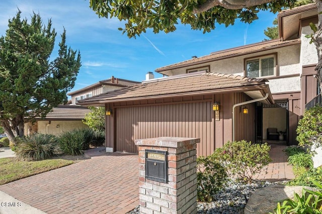 view of front of house featuring a garage and a patio area