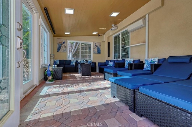 view of patio / terrace with outdoor lounge area and an AC wall unit