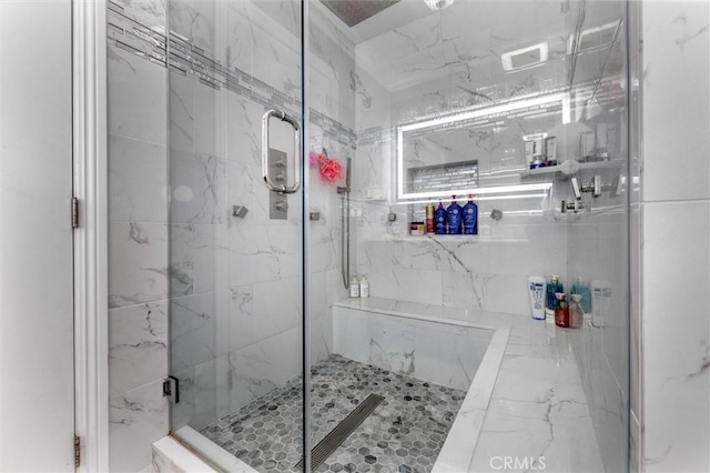 bathroom featuring a shower with door