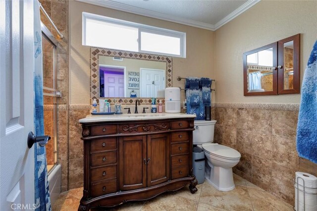 full bathroom with shower / bathtub combination, tile walls, vanity, toilet, and crown molding