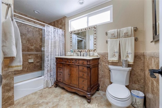 full bathroom with vanity, tile walls, shower / tub combo with curtain, and toilet