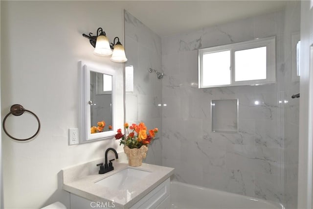 full bathroom featuring vanity, toilet, and tiled shower / bath