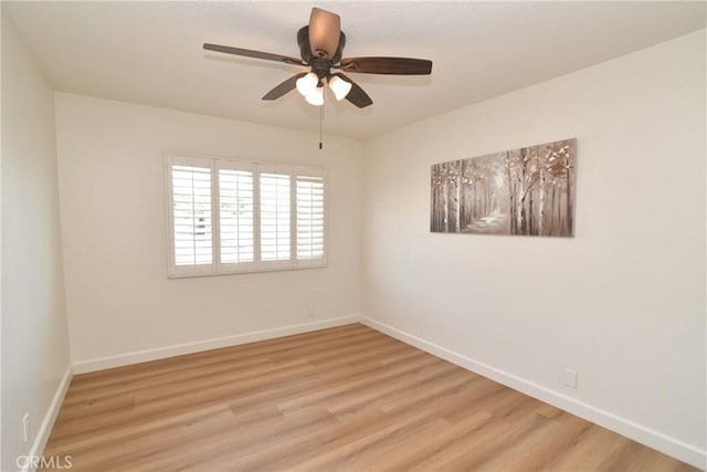 spare room featuring ceiling fan and light hardwood / wood-style flooring