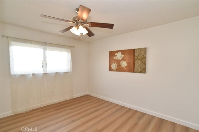 spare room featuring light hardwood / wood-style floors and ceiling fan