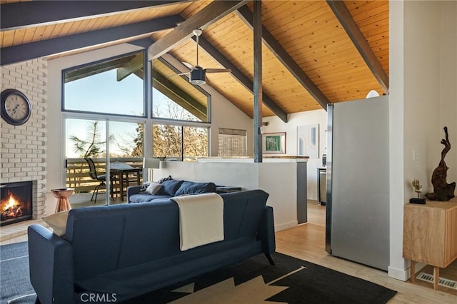 living room featuring a brick fireplace, light hardwood / wood-style floors, wooden ceiling, and beamed ceiling