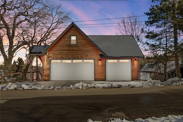 view of front of property featuring a garage and an outdoor structure