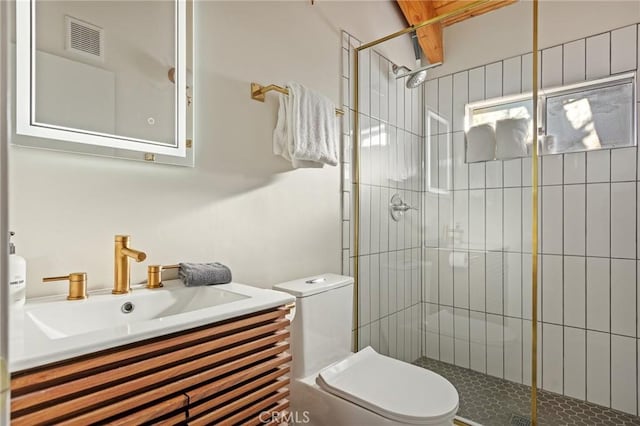 bathroom with vanity, an enclosed shower, and toilet