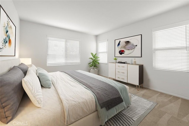 bedroom featuring light carpet