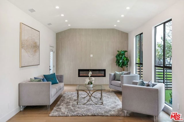 living room with lofted ceiling and light hardwood / wood-style floors