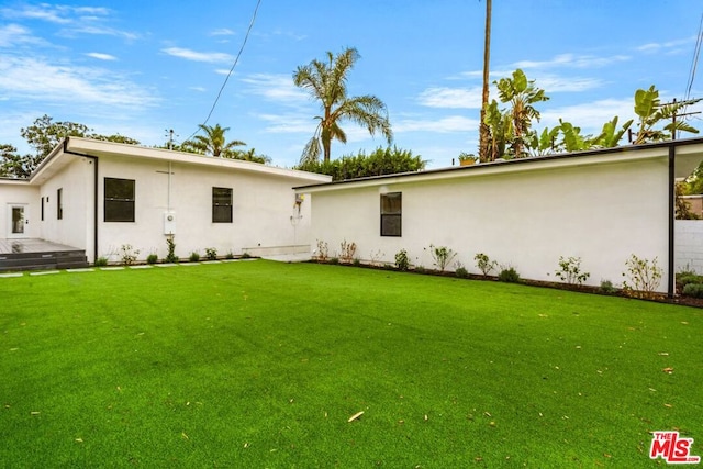 back of house with a yard