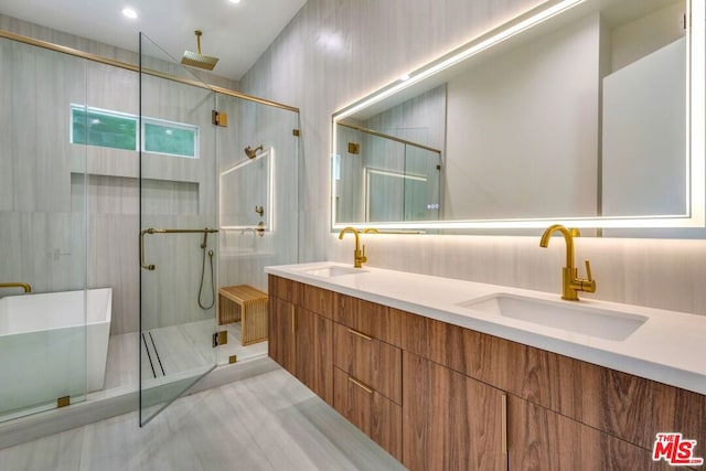 bathroom with walk in shower and vanity