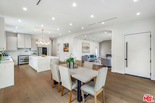 dining area with sink and hardwood / wood-style flooring