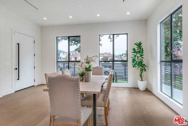 dining space with a healthy amount of sunlight and light wood-type flooring