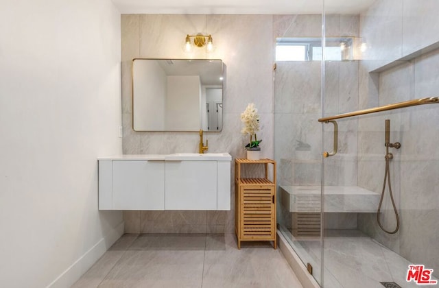 bathroom featuring vanity, an enclosed shower, and tile patterned floors