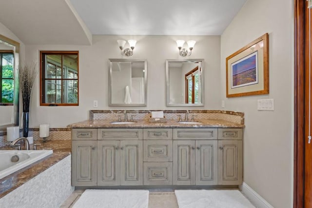 bathroom with a relaxing tiled tub, tile patterned floors, and vanity