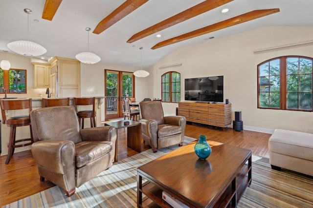 living room featuring french doors, lofted ceiling with beams, and light hardwood / wood-style flooring