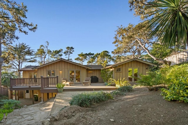 back of house featuring a deck and french doors