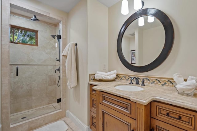 bathroom featuring vanity and a shower with door