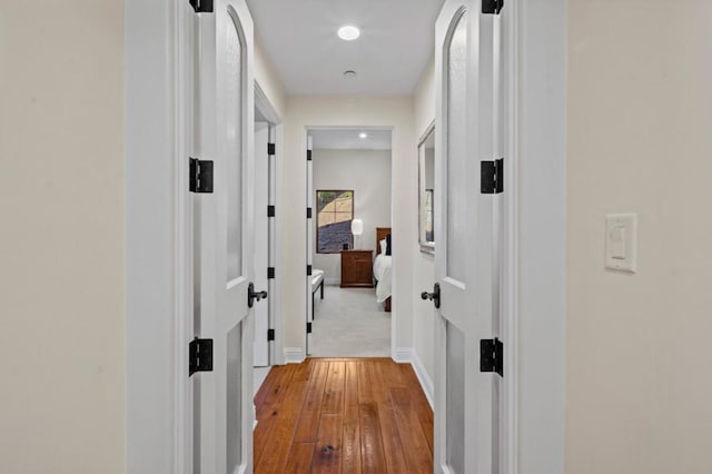 corridor featuring light hardwood / wood-style floors