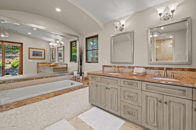 bathroom with vanity, separate shower and tub, and vaulted ceiling