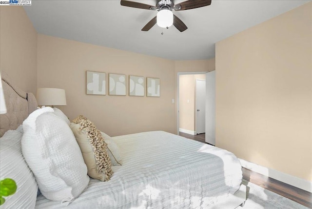 bedroom with dark wood-type flooring and ceiling fan