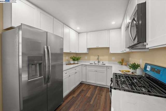 kitchen featuring white cabinetry, sink, stainless steel appliances, and dark hardwood / wood-style floors