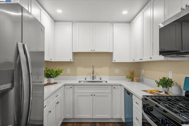 kitchen featuring sink, stainless steel appliances, white cabinets, and light stone countertops