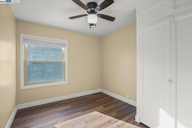 unfurnished bedroom with ceiling fan and dark hardwood / wood-style floors