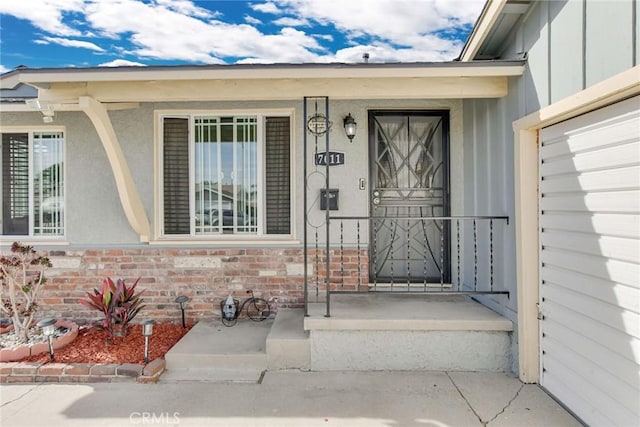 view of exterior entry with brick siding