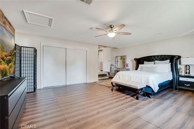 bedroom with wood-type flooring, a closet, and ceiling fan