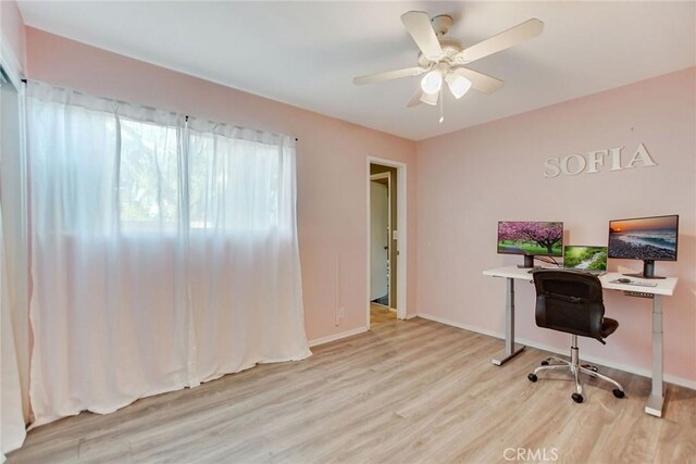 office area with ceiling fan and light hardwood / wood-style floors