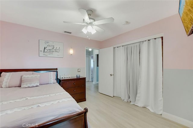 bedroom with visible vents, ceiling fan, baseboards, and light wood-style floors