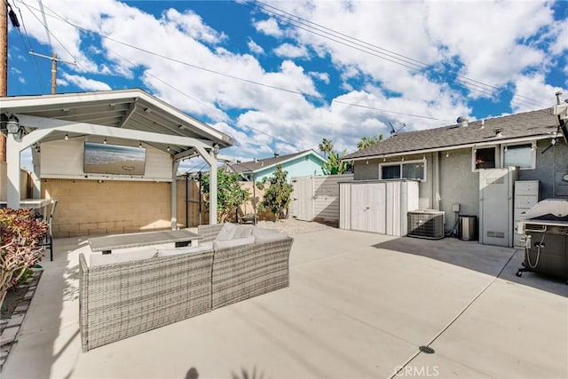 view of patio / terrace featuring outdoor lounge area, central AC, and a shed