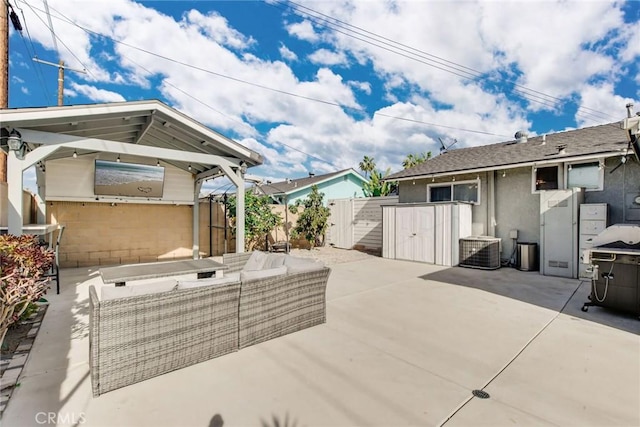 view of patio featuring outdoor lounge area, fence, and central AC