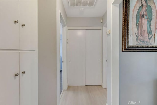 corridor with visible vents and light wood-type flooring