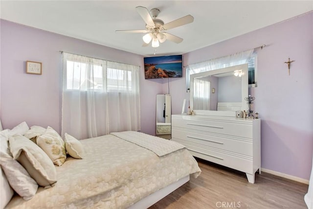 bedroom with ceiling fan and light wood-type flooring