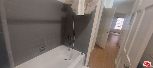 bathroom featuring hardwood / wood-style floors and shower / bath combination