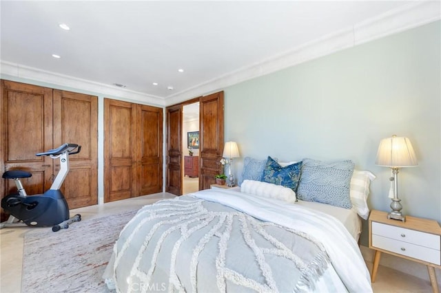 bedroom featuring multiple closets, crown molding, and recessed lighting