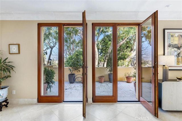 doorway featuring french doors and light tile patterned flooring