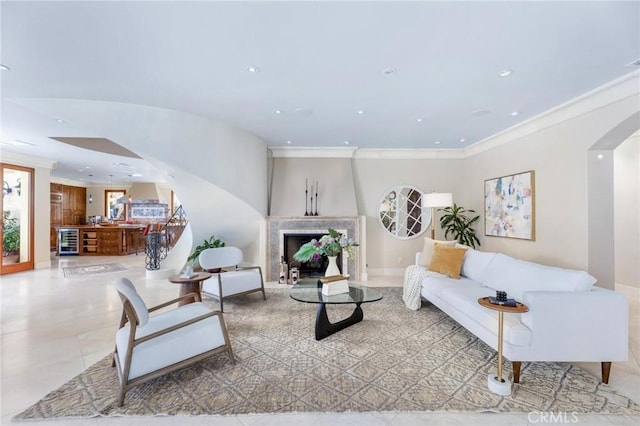 living room with ornamental molding and beverage cooler