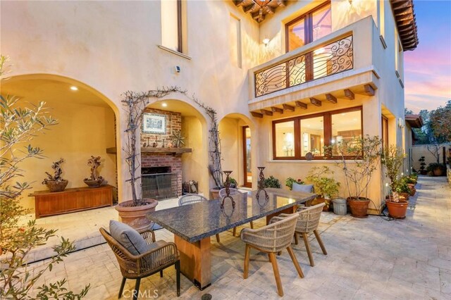 dining space featuring an outdoor brick fireplace