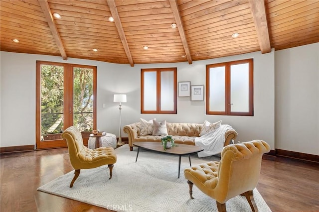 living area with wooden ceiling, lofted ceiling with beams, baseboards, and wood finished floors