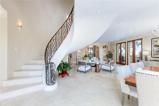 interior space featuring crown molding, built in shelves, and an inviting chandelier