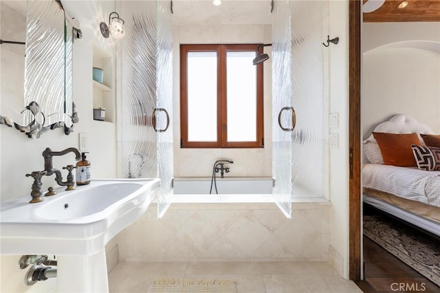 ensuite bathroom featuring a tub, french doors, ensuite bathroom, and tile patterned floors