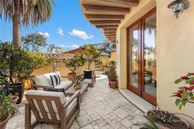 balcony featuring a patio area, an outdoor living space, and grilling area