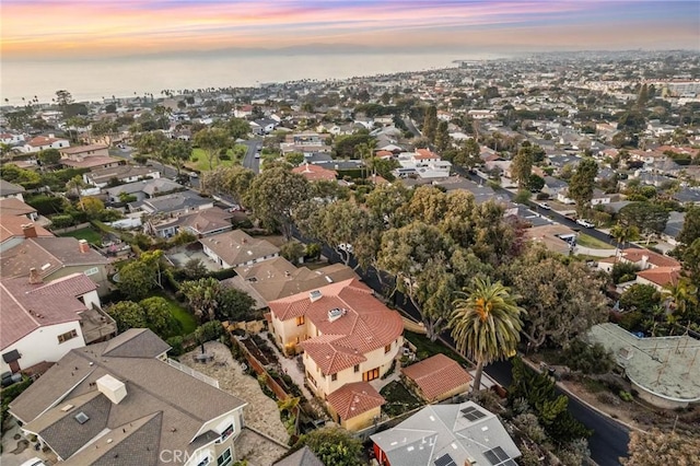 aerial view at dusk featuring a residential view