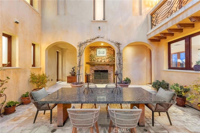 view of patio with an outdoor brick fireplace