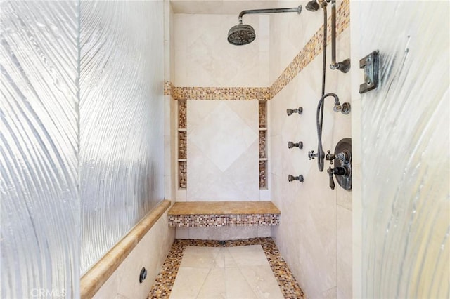 bathroom with a tile shower