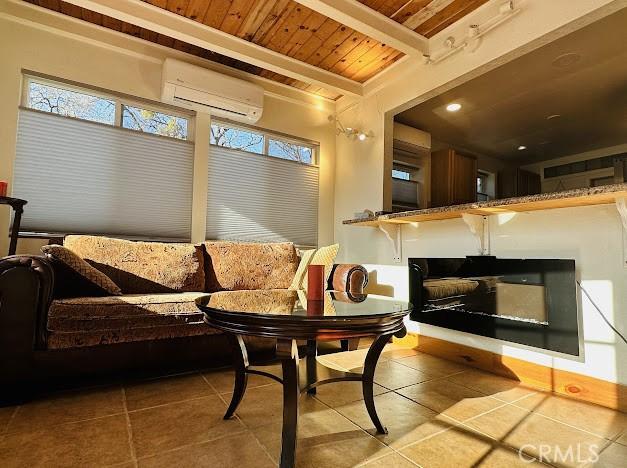 sunroom / solarium featuring a wealth of natural light, a wall mounted AC, and wood ceiling